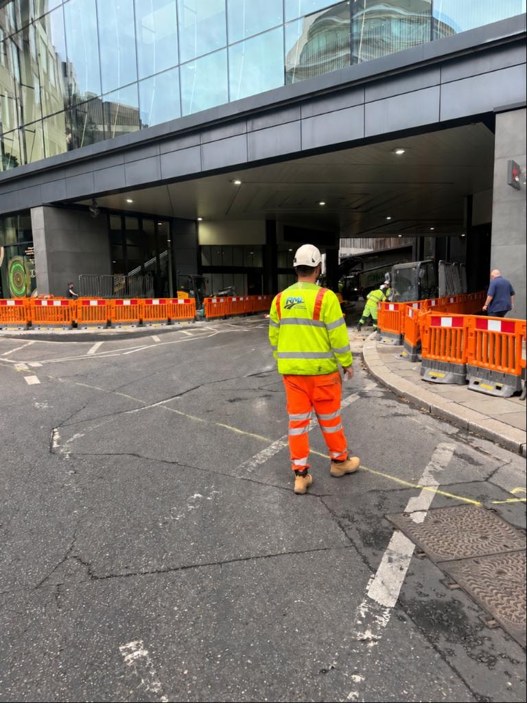 Traffic management operative working safely on a UK road site